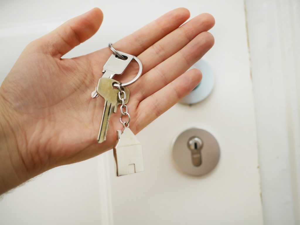 Hand holding house keys.