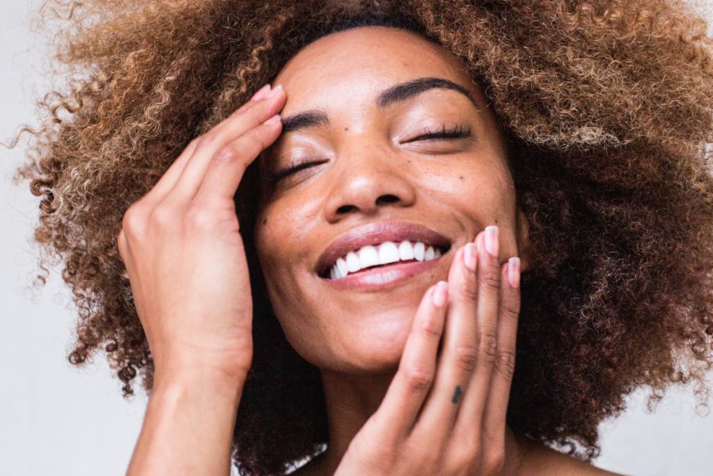 Happy Lady Applying Skincare