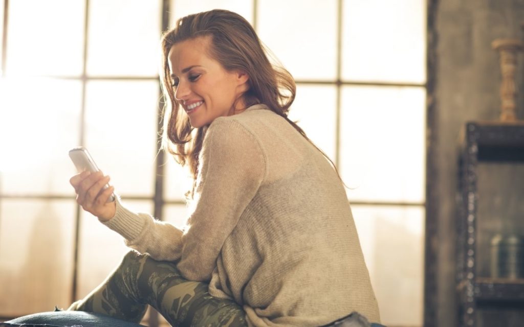 Woman smiling at her phone