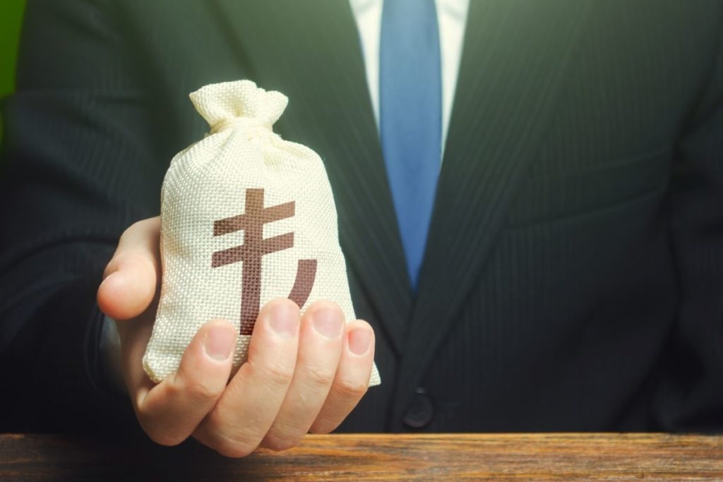 Man Holding bag of money