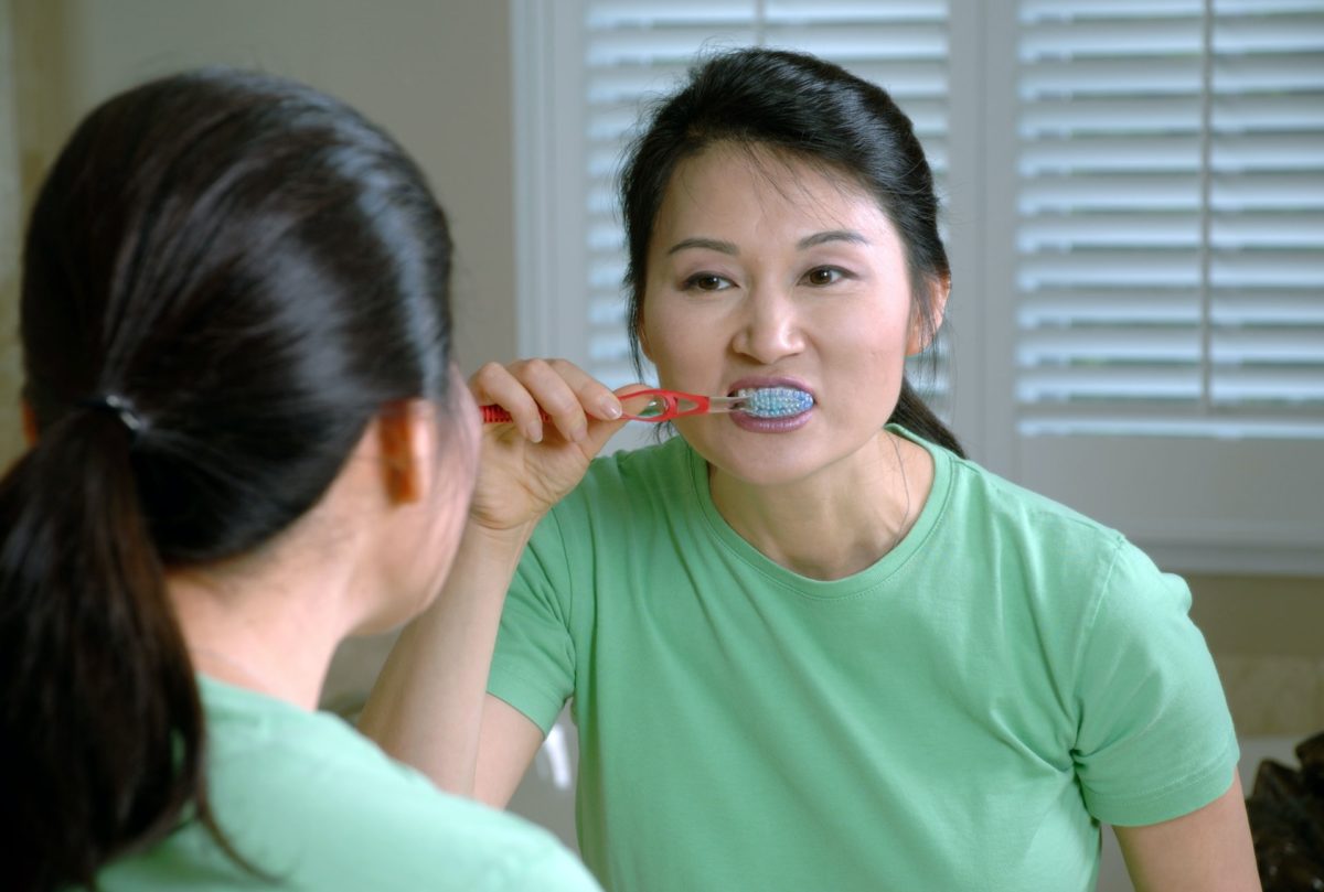 woman brushing teeth