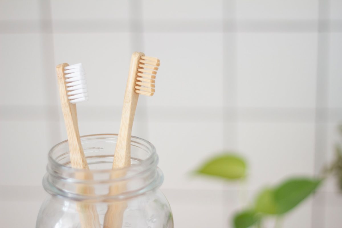 two toothbrushes in jar